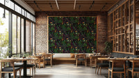 A dining room decorated with a dark botanical mural

