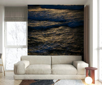 A close-up of the ocean water hitting the rugged rocks.

