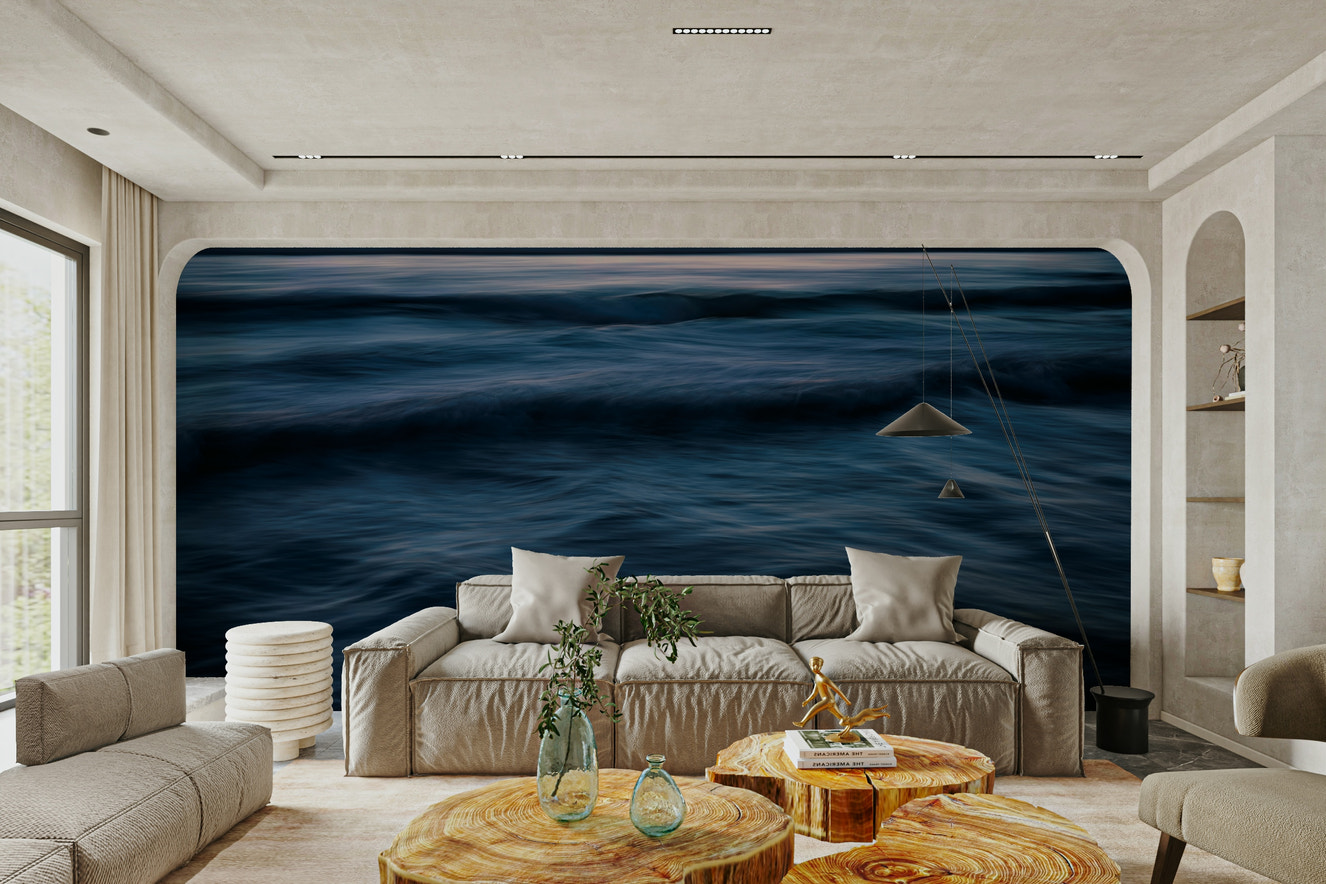 A contemporary living room with a large ocean wave wall mural.

