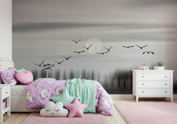 Wall mural depicting birds in flight over a glowing, mystical lunar sky.