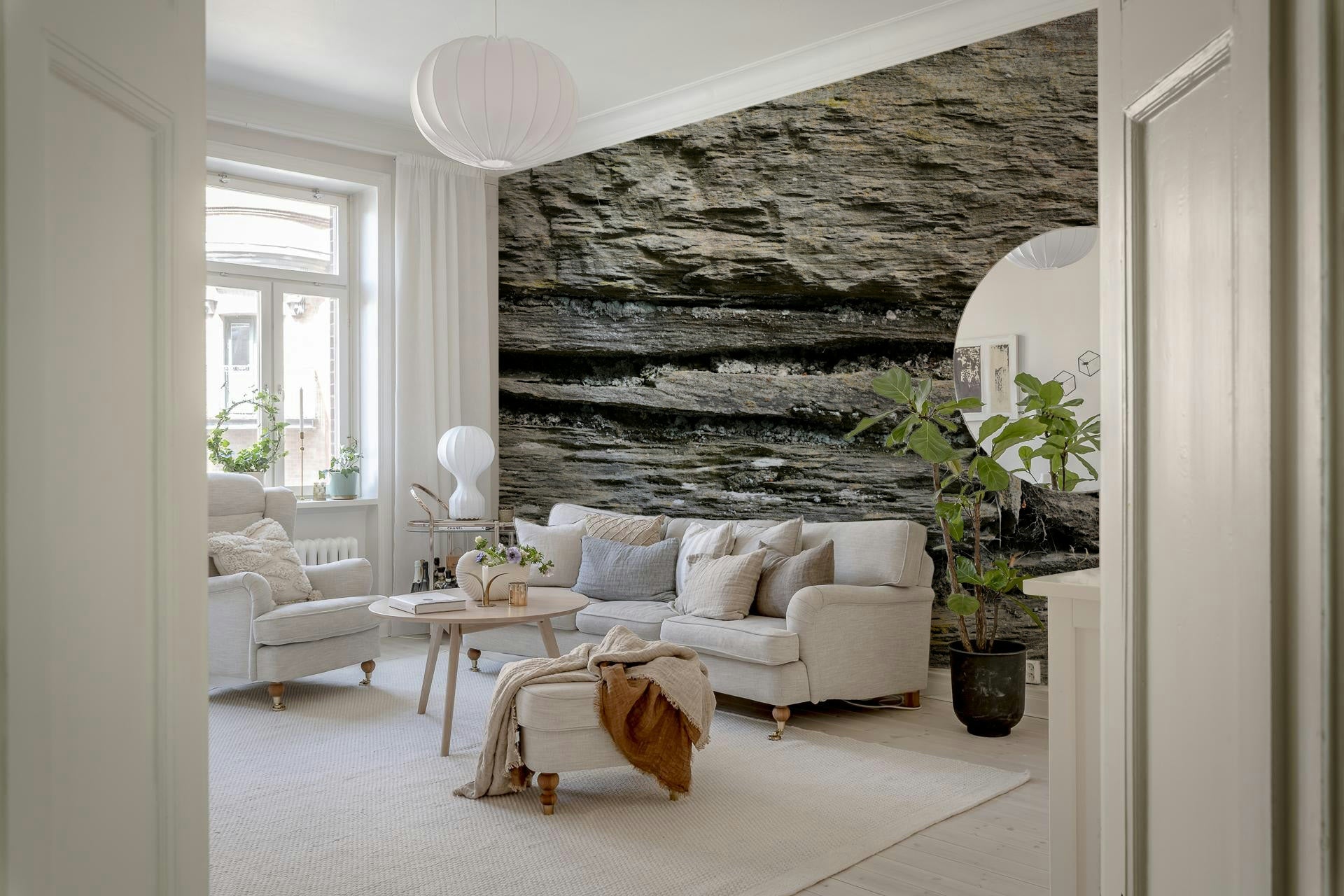 Textured wall mural with stacked stone layers creating depth and a rugged, authentic accent wall.