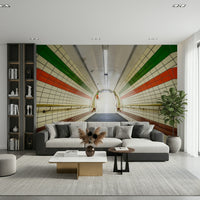 A subway tunnel wallpaper featuring tiled walls with bold green and red stripes descending toward a bright exit.