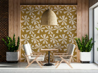 Patterned wallpaper featuring stylized cream floral bursts across a textured golden background.