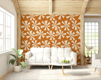Retro bloom burst wallpaper featuring cream starburst flowers on a warm orange background.