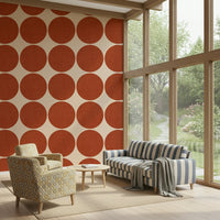 Beige wallpaper decorated with large terracotta dots that have a subtle fabric-like texture