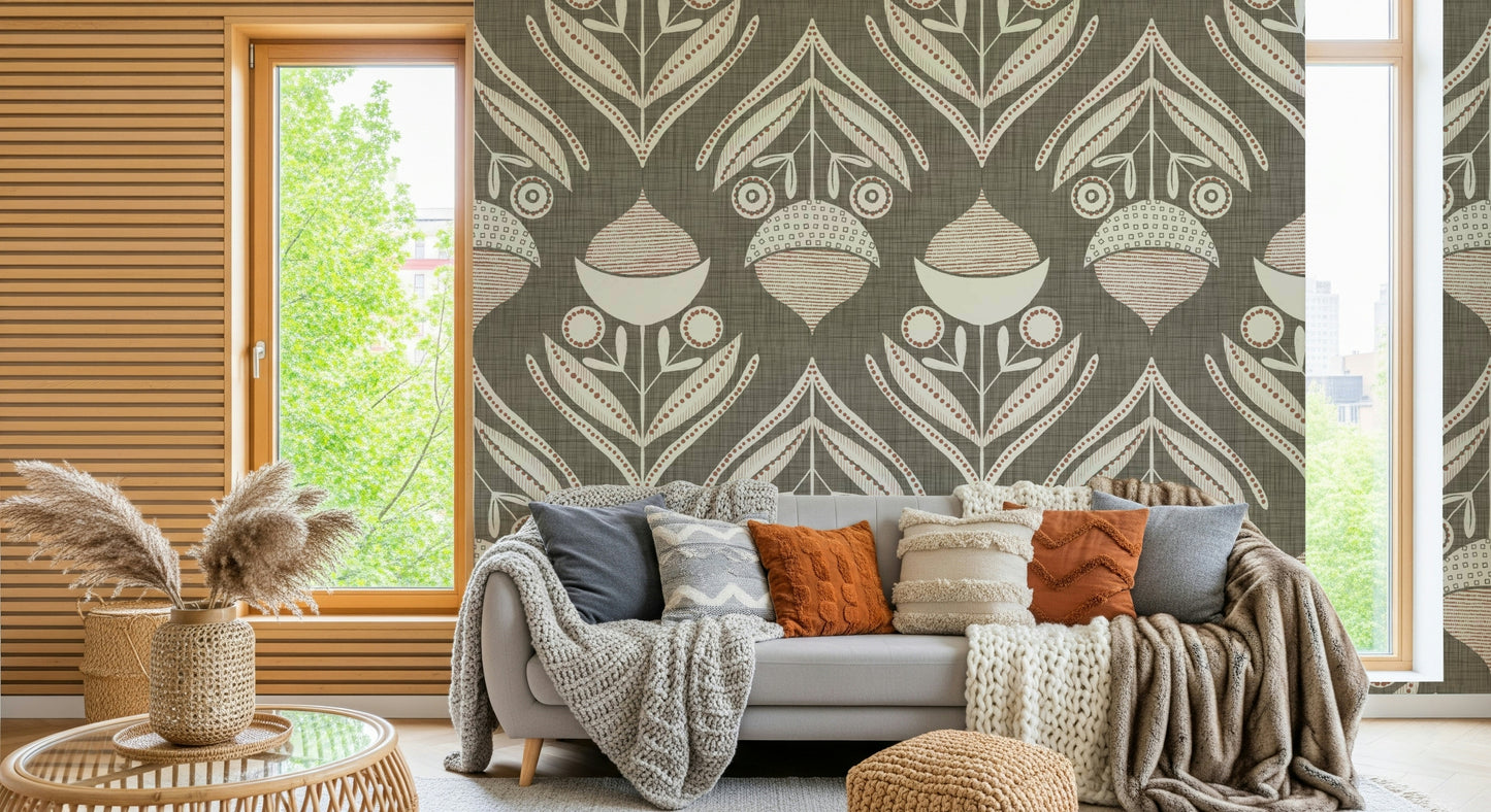 Stylized botanical pattern with symmetrical blooms and curved leaves in muted tones over a textured gray base