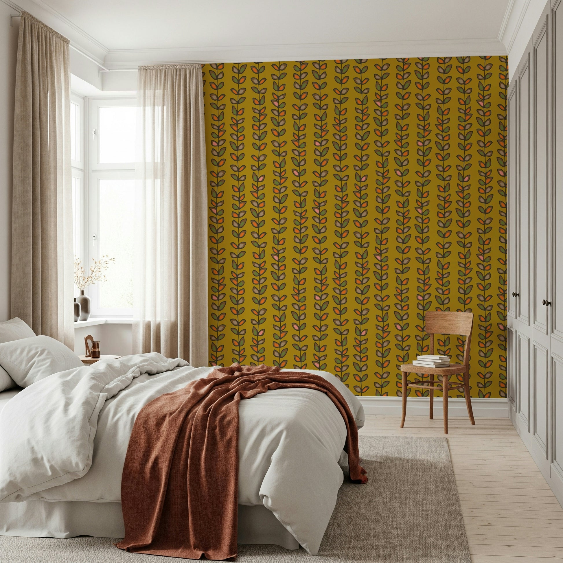 Colorful leaf clusters arranged along vertical vines creating a vintage-inspired wallpaper on mustard yellow.