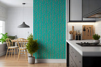 Retro-inspired vines with colorful leaves forming a bold, lively wallpaper on a turquoise backdrop.
