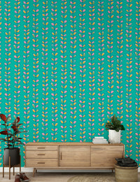 Bright turquoise wallpaper decorated with evenly spaced retro leaves in pink, yellow, and green tones.