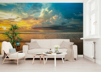 A calm tropical horizon with gentle waves and dramatic storm clouds shown in the Borneo Beach wallpaper.