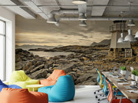 Wall mural of a tranquil coastline with a lighthouse overlooking the ocean from a rocky outcrop.