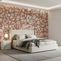 Clay-toned stone terrazzo wall mural. Bright contrasting flecks.