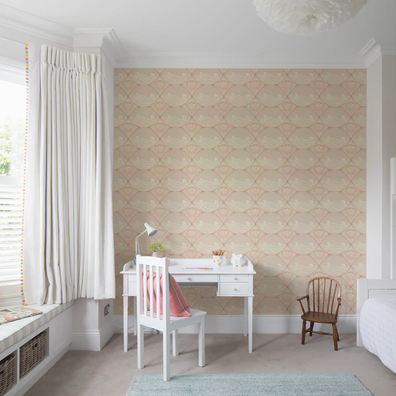 Coastal shell pattern wallpaper placed in a soft minimalist nursery setup