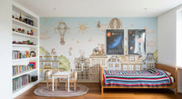 Pastel city wall mural with cats, buildings, and sky elements