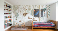 Blue forest wall mural in a bedroom with deer, foxes, rabbits, and foliage