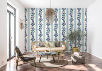 Violet floral wallpaper paired with pale blue stripes and botanical artwork