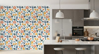 Coral, yellow, navy, and blue blooms across Playful Meadow wallpaper