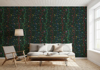 Colorful bird shapes lift this woodland wallpaper on a deep green base