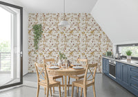 Cream botanical wallpaper showing slim stems, beige florals, and plum leaves
