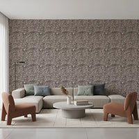Tonal contrast runs through the organic pebble mosaic wallpaper on dark espresso ground
