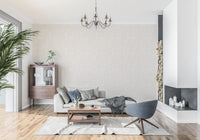 A lounge dressed in cream pebble pattern wallpaper