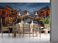 Red lanterns and stone arch bridge in old town wall mural at dusk