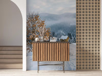 Tucked into misty hills, a small yellow cabin anchors the snowy haven wall mural