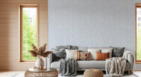 Hallway lined with watercolor strokes wallpaper in soft blue-gray wash tone.