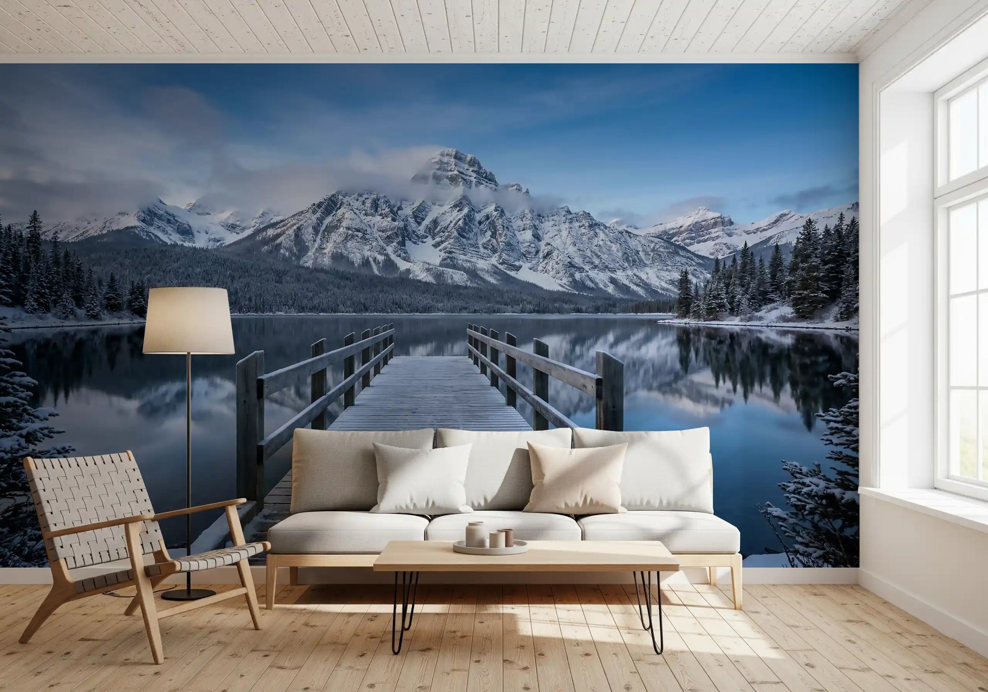 Dock and mountain wall mural centered on a living room back surface in blue