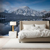 Frosted mountain wall mural above a bedroom in pale blue and grey tones