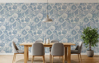 A dining room wrapped in muted blue boho seashell and coral wallpaper