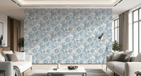 Boho seashell wallpaper in dusty blue seen in a modern living room corner