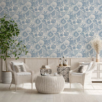 A lounge featuring the blue boho seashell coral wallpaper from floor up