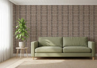 Linen-style ground holding organic stone mosaic wallpaper in earthy tones