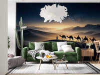Long shadows trail the riders along the dune in this desert caravan wall mural