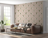 A cream backdrop balances the olive greens and earthy borders of this Tuscan wallpaper