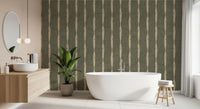 Warm beige distressed stripe wallpaper with chalky edges over a muted green base