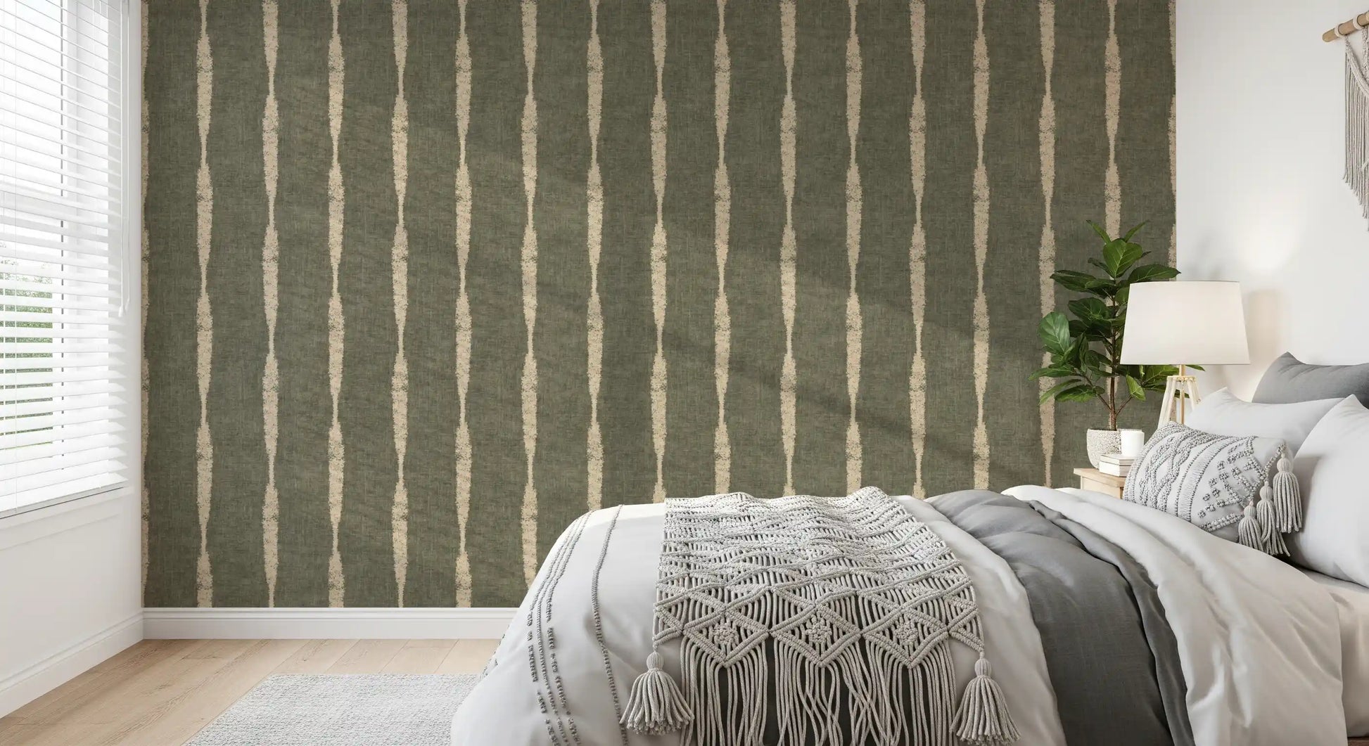 Drifting beige columns and muted green texture style this bedroom in stripe wallpaper