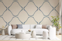 Dotted Lattice wallpaper gives a living room a calm coastal-boho backdrop.
