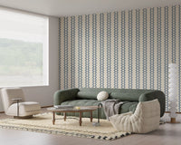 Living room dressed in zellige striped wallpaper in muted slate blue and cream