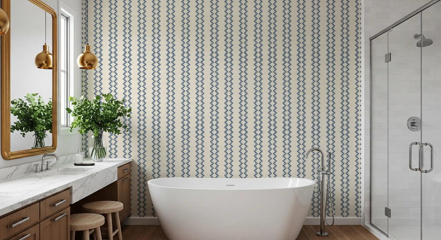 Vertical chains of slate blue motifs run down this zellige striped wallpaper
