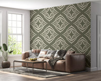 Geometric boho wallpaper in palm green steadies a bright sitting room