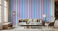 Lounge area accented by blue and lilac vertical stripe wallpaper overhead