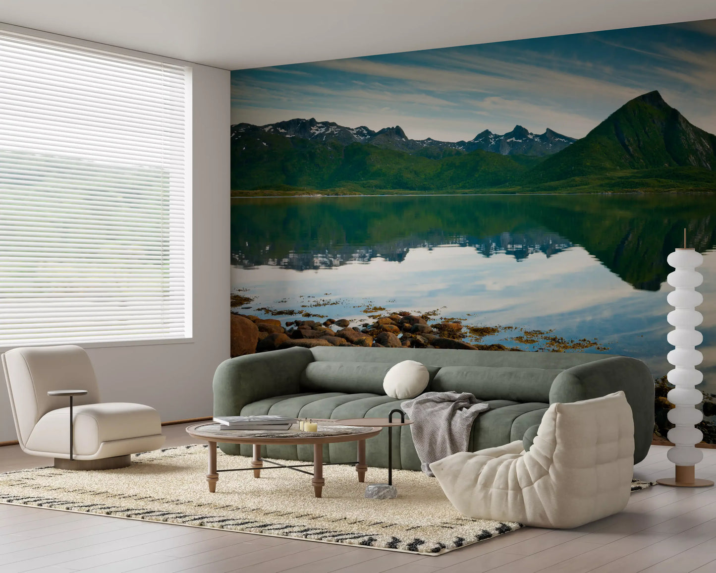 Mountain lake view wraps a calm lounge in the Emerald Peaks Mirror Waters wall mural.