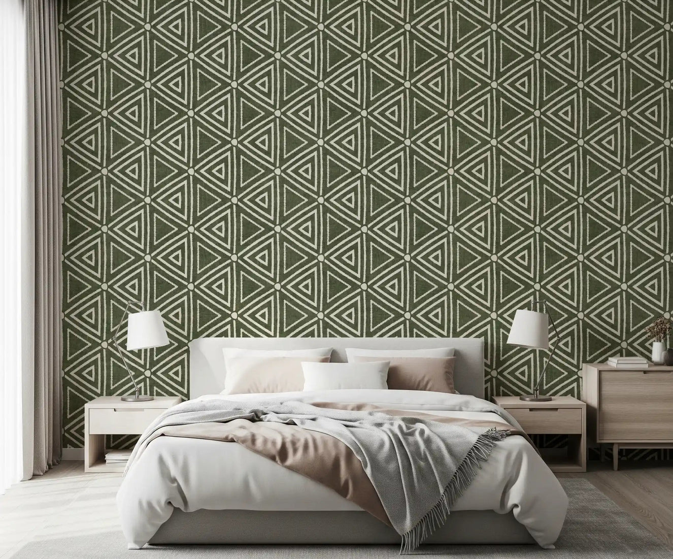 Moss green triangle wallpaper behind a calm bedroom in a boho, earthy scheme