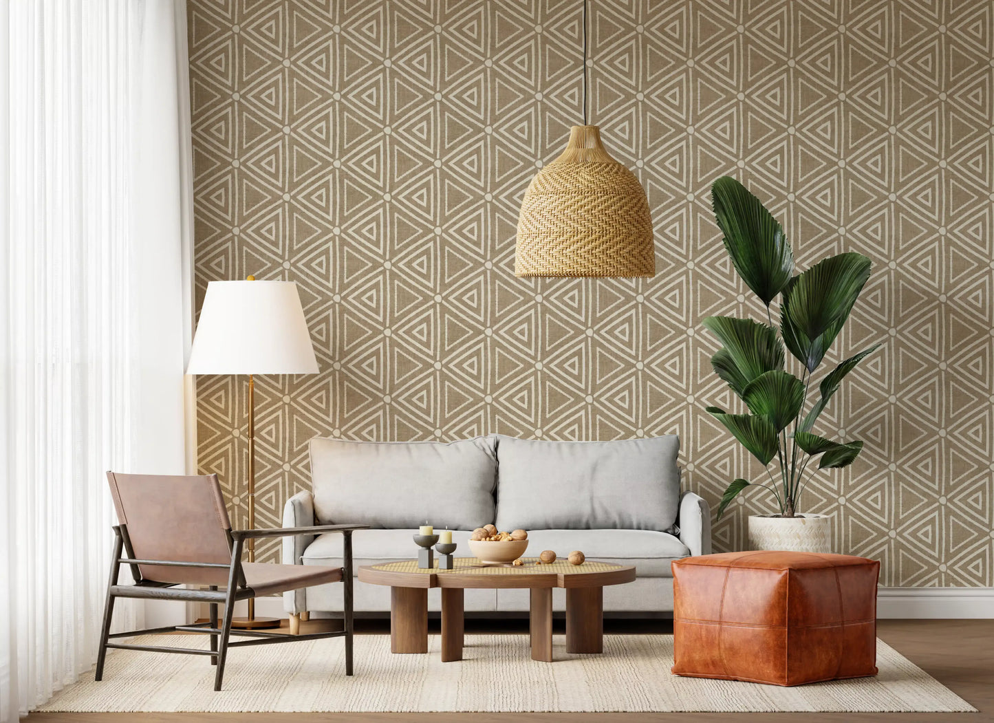 Mudcloth Geometric Triangles wallpaper lends the lounge a quiet boho backdrop