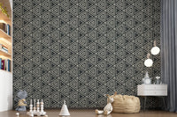 Chalky ivory shapes contrast deep black in the geometric mudcloth wallpaper pattern
