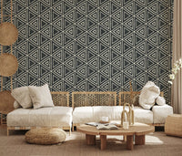 A laid-back lounge gains tribal warmth from charcoal geometric wallpaper