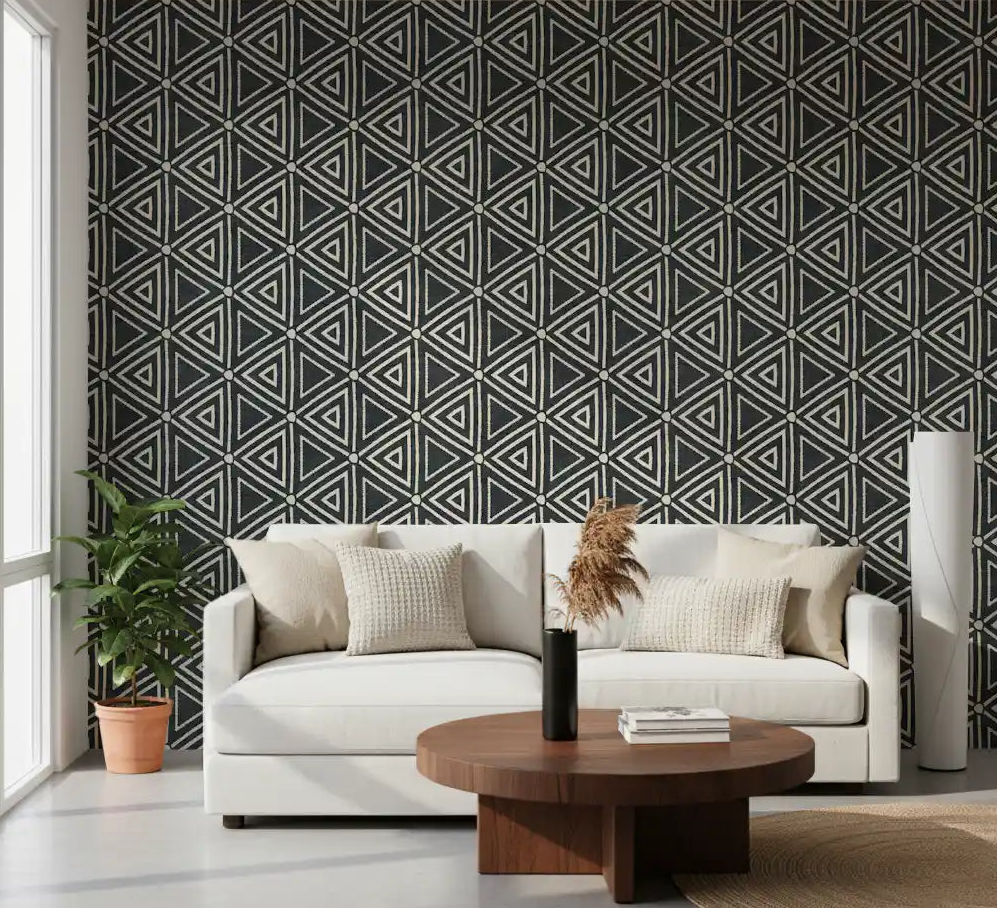 Cream triangles on charcoal frame a calm, neutral living room in boho mudcloth wallpaper