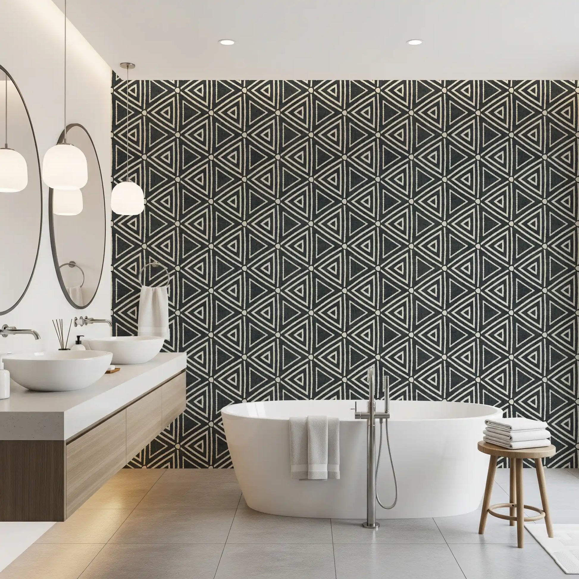 Irregular triangle outlines lend the charcoal mudcloth wallpaper a woven, tribal look